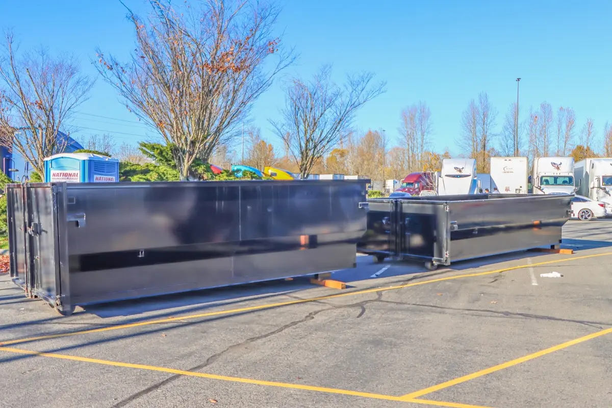 Professional dumpster rental service with roll-off container on residential driveway in Moorestown